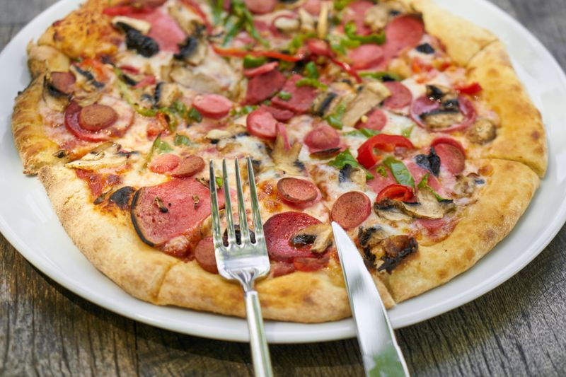 Jet's pizza signature deep dish pizza with rich tomato sauce and melted cheese